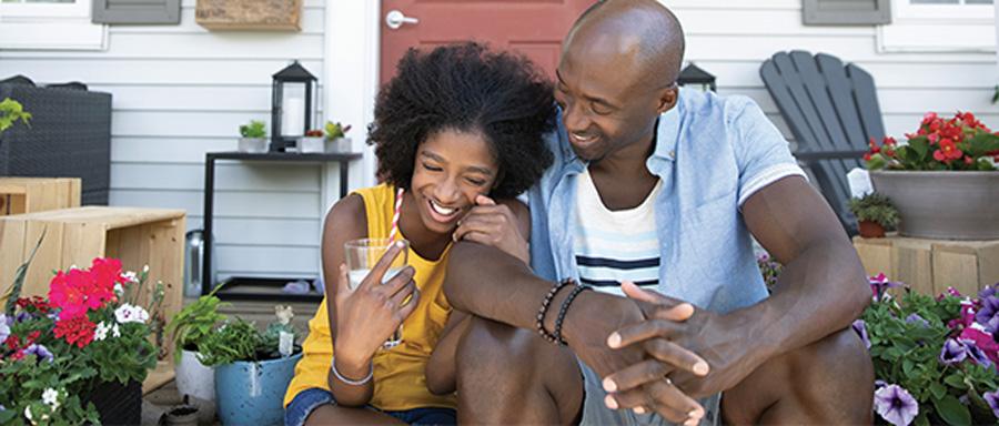 Dad and a daughter together on a porch smiling